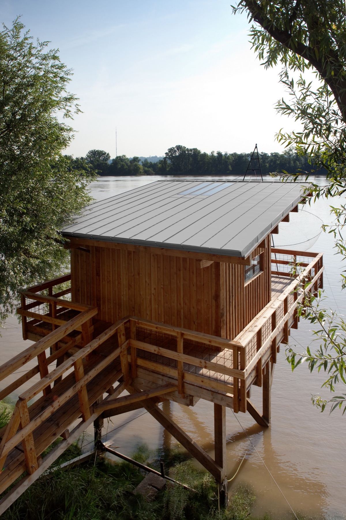 Carrelet contre le ciel d'été sur la rive de la Gironde, terrasse couverte au-dessus de l'eau